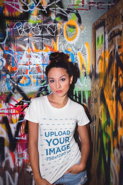 Tshirt Mockup of a Woman in a Bathroom with Graffiti