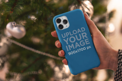 Phone Case Mockup Featuring a Christmas Tree in the Background 5174-el1