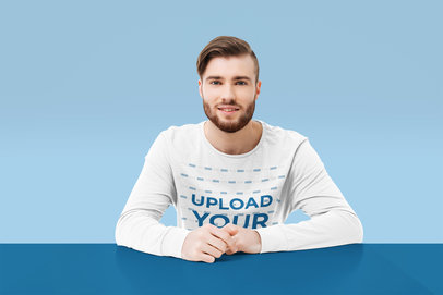 Long Sleeve Tee Mockup of a Happy Man Sitting At a Customizable Table 40156-r-el2